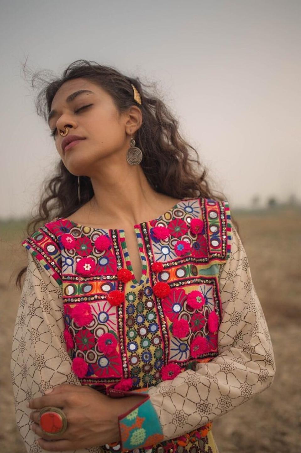 A model wears a meenakari tunic by Aman Kay Rang.