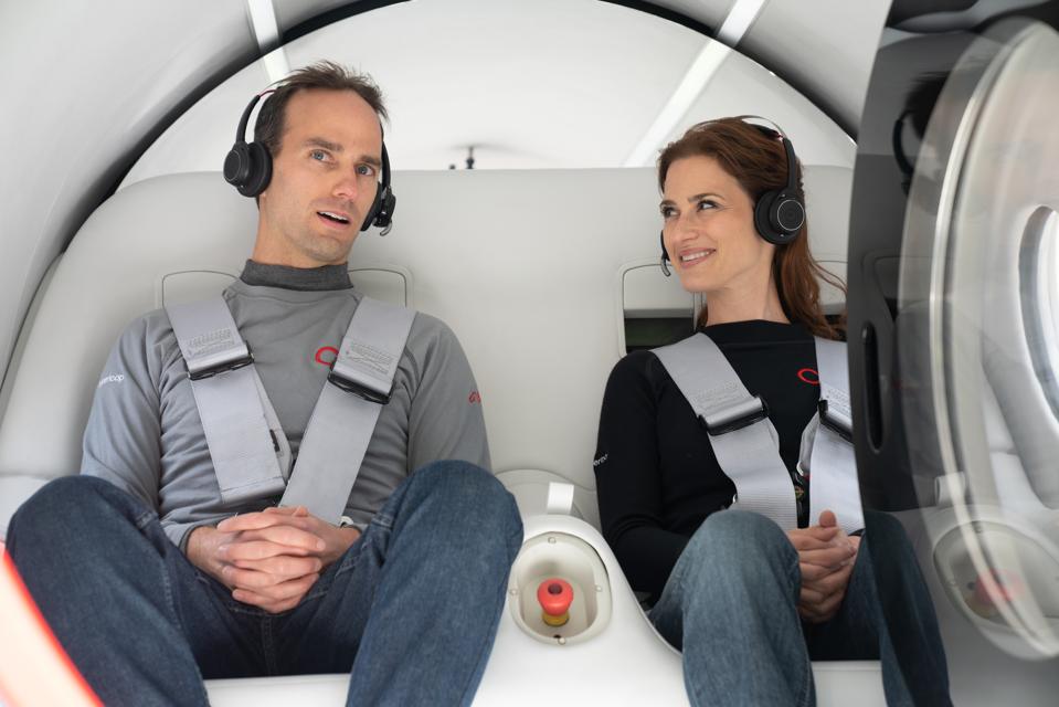 Josh Giegel and Sara Luchian seated in a pod for the Virgin Hyperloop test run.