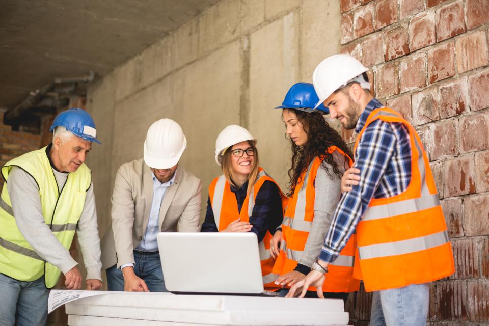Beautiful female Construction workers talking on site