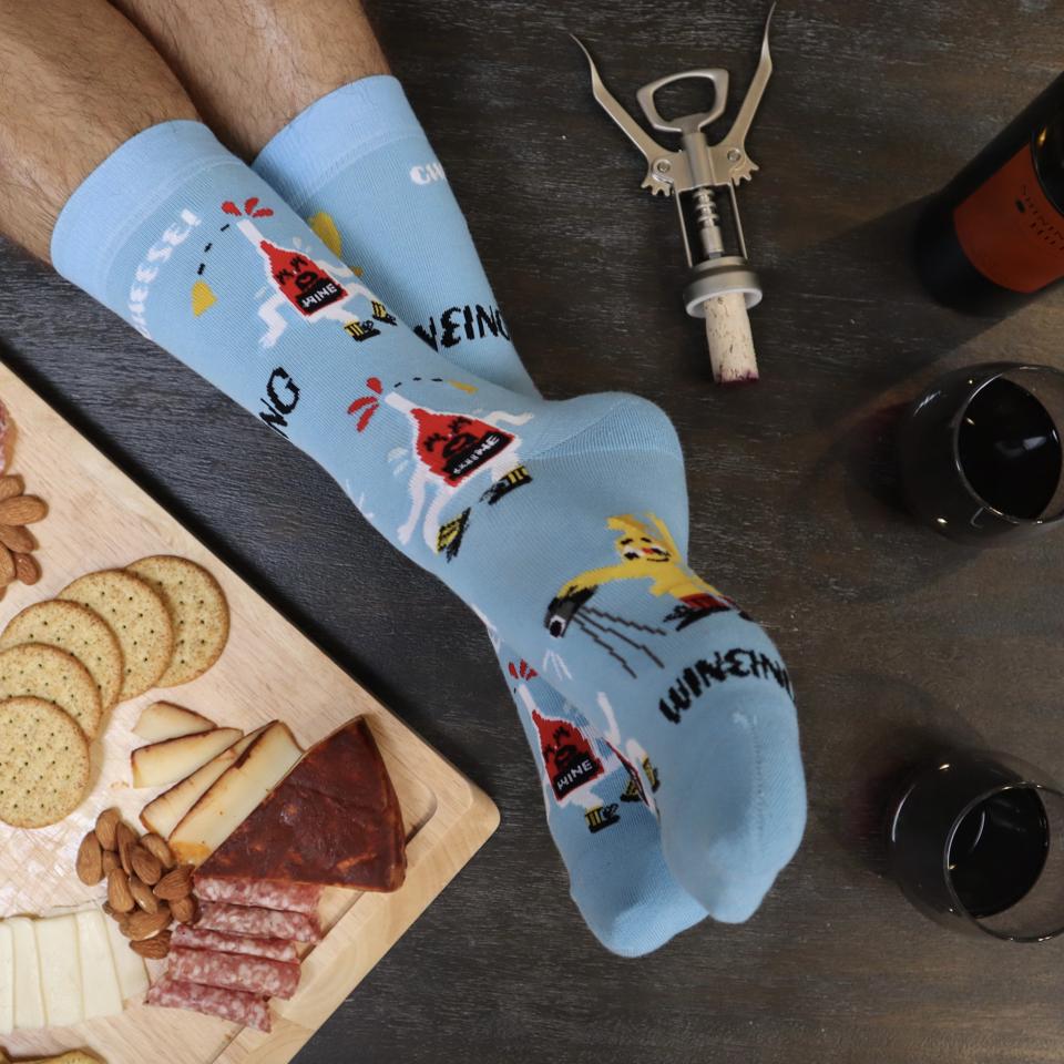 Pop a cork and bring out the brie. Now all you need is these Whine & Cheese socks.