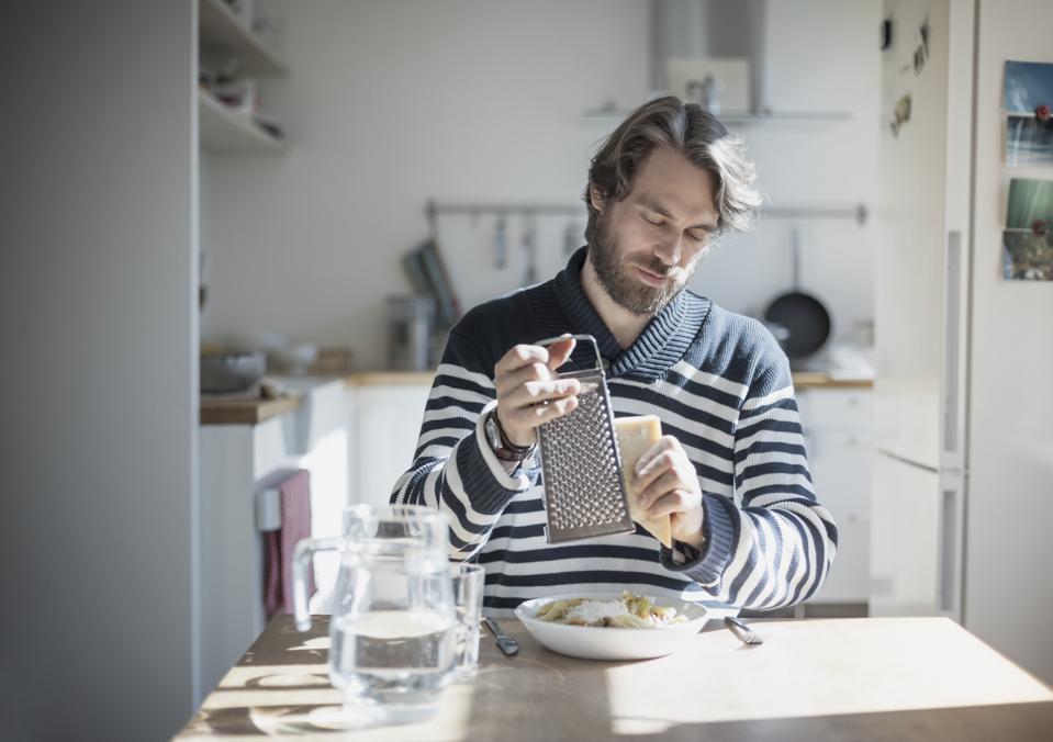 Portrait of bearded man eating at home
