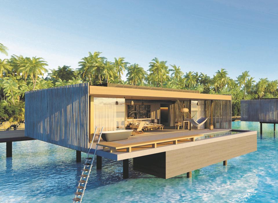 The villas at Patina Maldives hotel are on stilts above the bright turquoise Indian Ocean