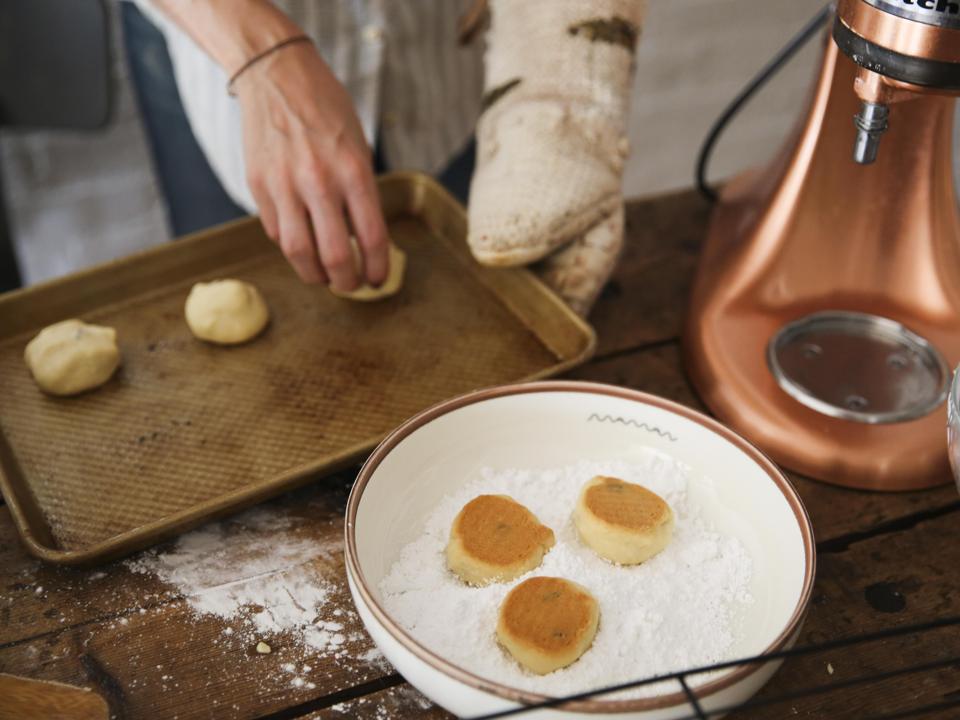 Woman making snowball shortbread cookies,