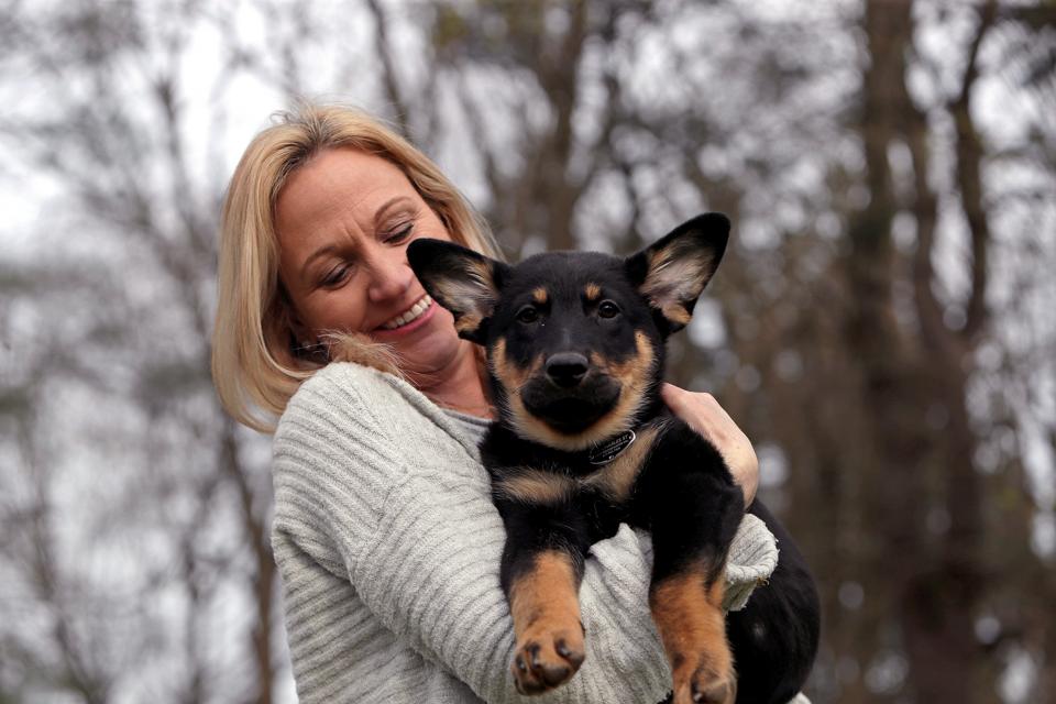 BOSTON, MA - APRIL 17: Jen Menard poses with her adopted German Shepard puppy Oakley (Photo by Barry Chin/The Boston Globe via Getty Images)
