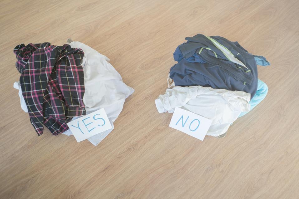 cleaning and sorting the clothes, two heap of textile. choose yes or no