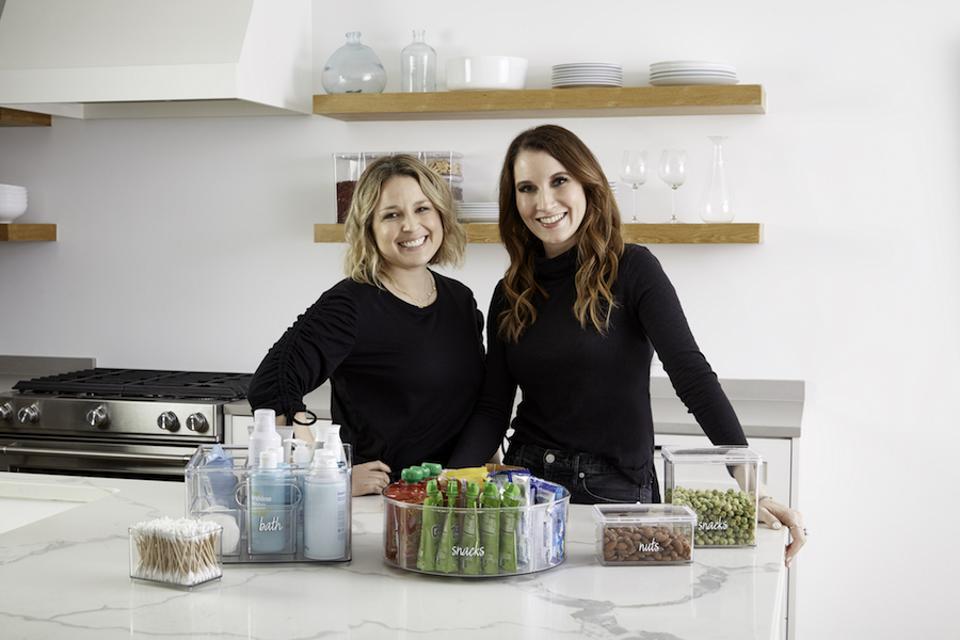 The home edit container store storage bins on a marble countertop
