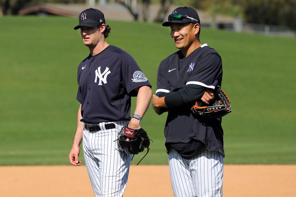 Right-handed Yankees pitchers Gerrit Cole and Masahiro Tanaka standing around.