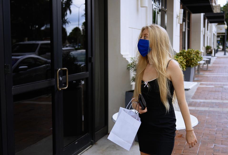 Woman wearing a protective mask while shopping in the city