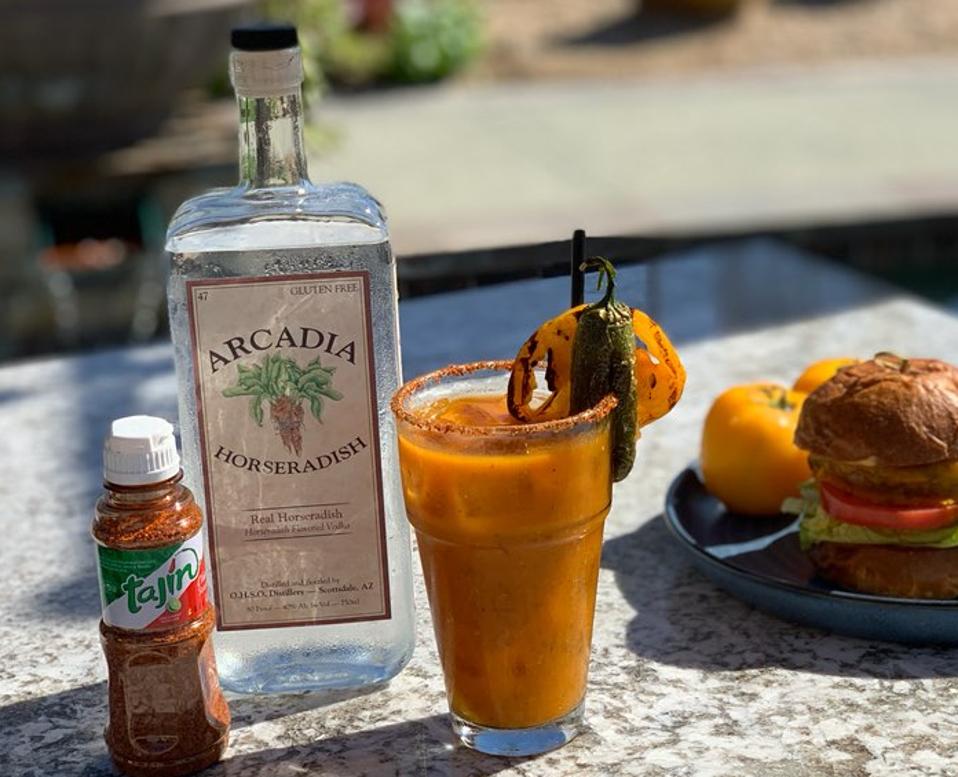 Bottle of vodka, Bloody Mary, and burger on a plate