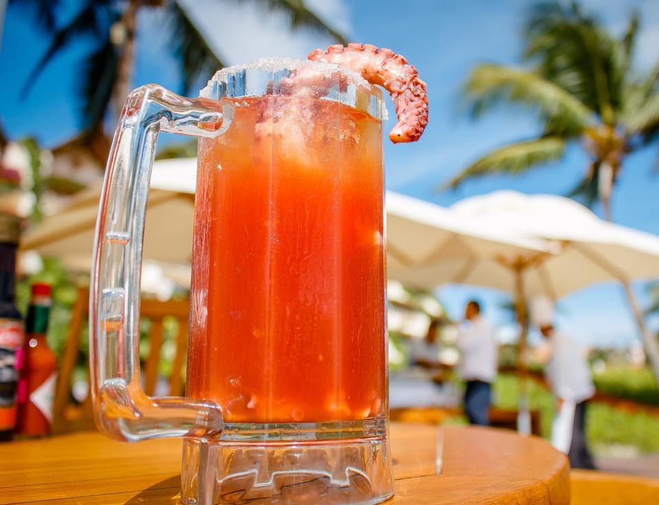 Bloody Mary in a tropical setting, garnished with octopus tentacle