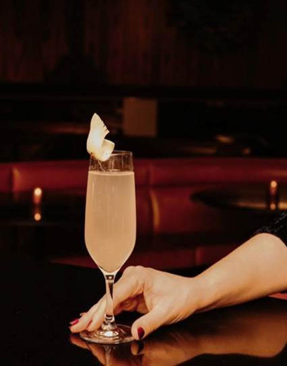 woman's hand with a french 75 cocktail
