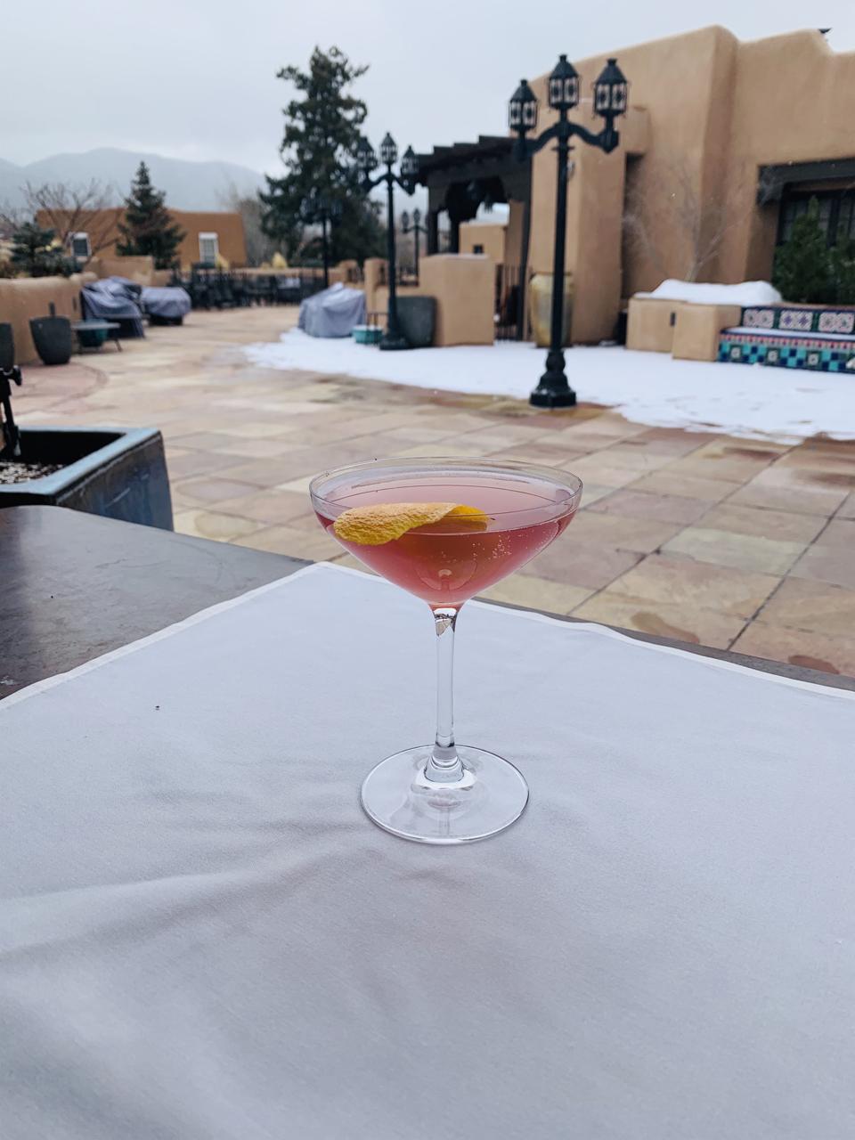 Champagne cocktail with Santa Fe backdrop