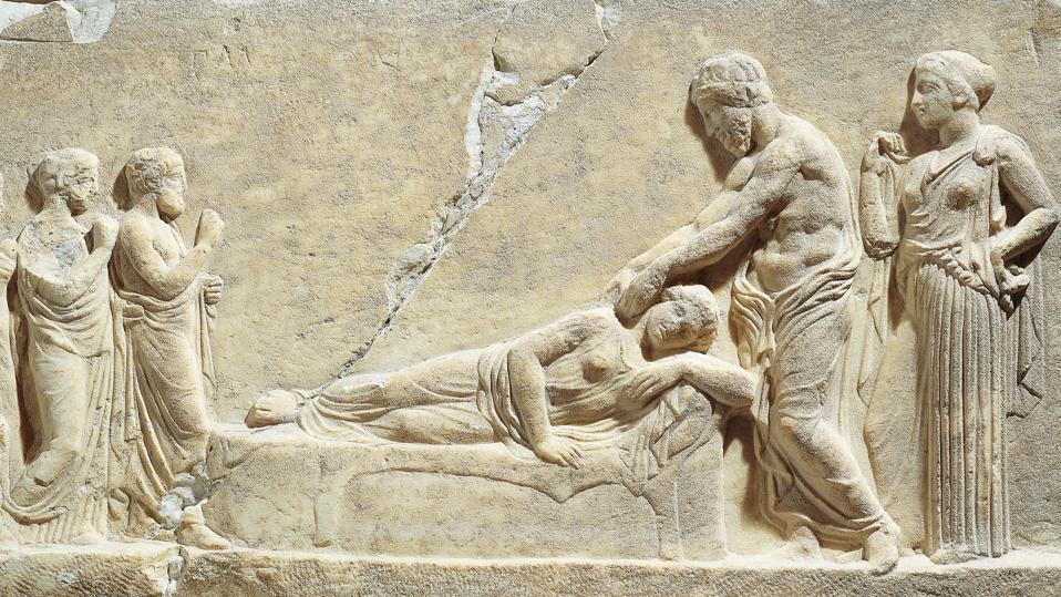 Marble relief depicting Asclepius or Hippocrates treating ill woman, from Greece