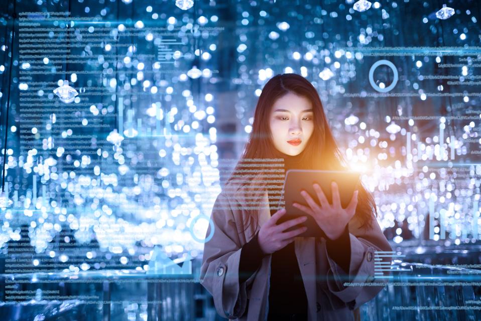 young woman uses digital tablet on virtual visual screen at night