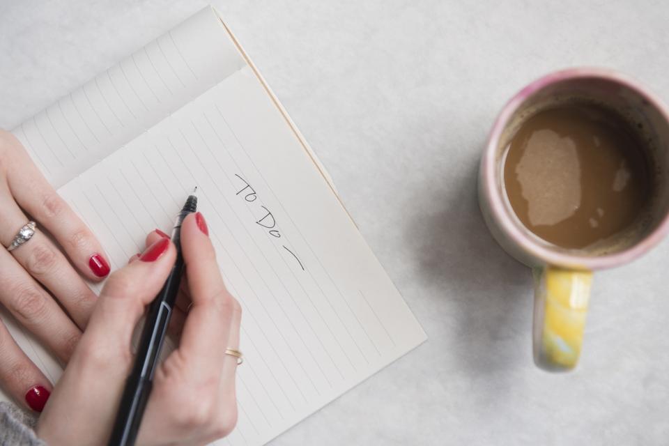 Woman writing in notepad