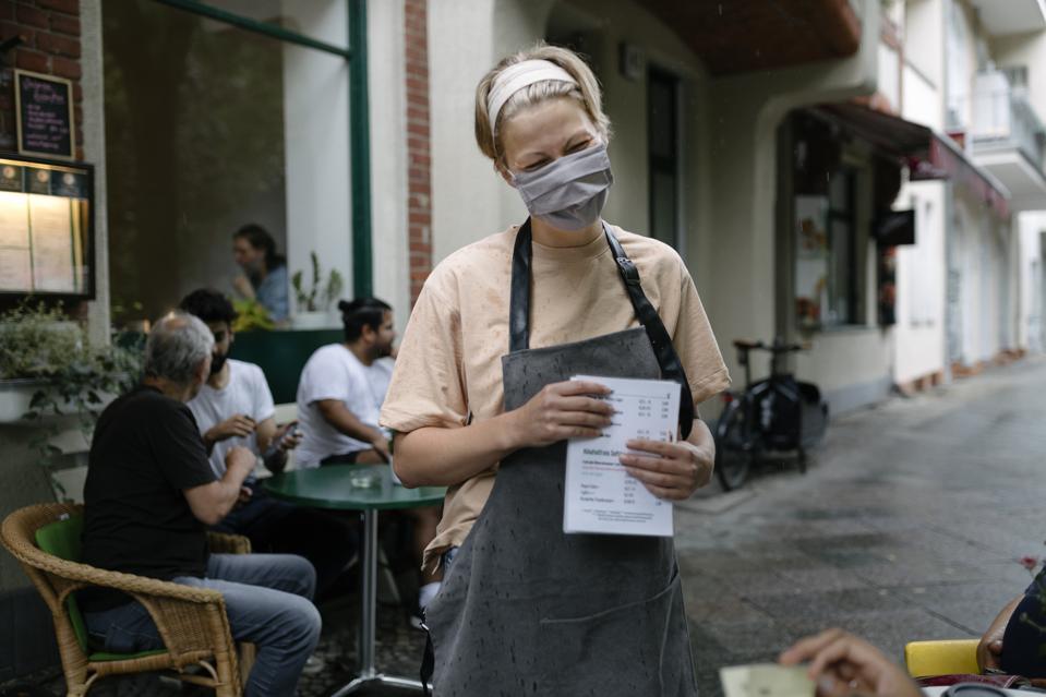 Waitress Wearing Face Mask Talking To Customers