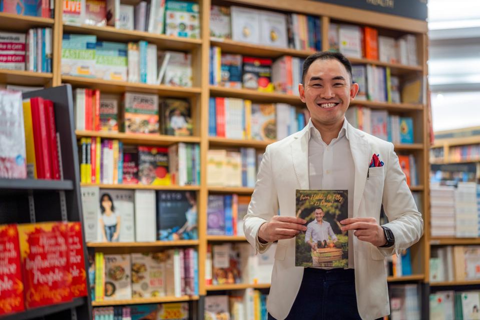 Mark Leong holding his book From Fabby to Fitty