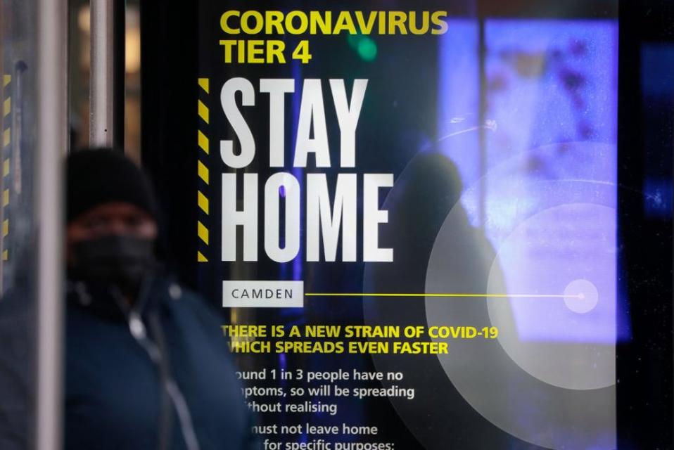 A Coronavirus Tier 4 Stay Home poster near King's Cross railway station