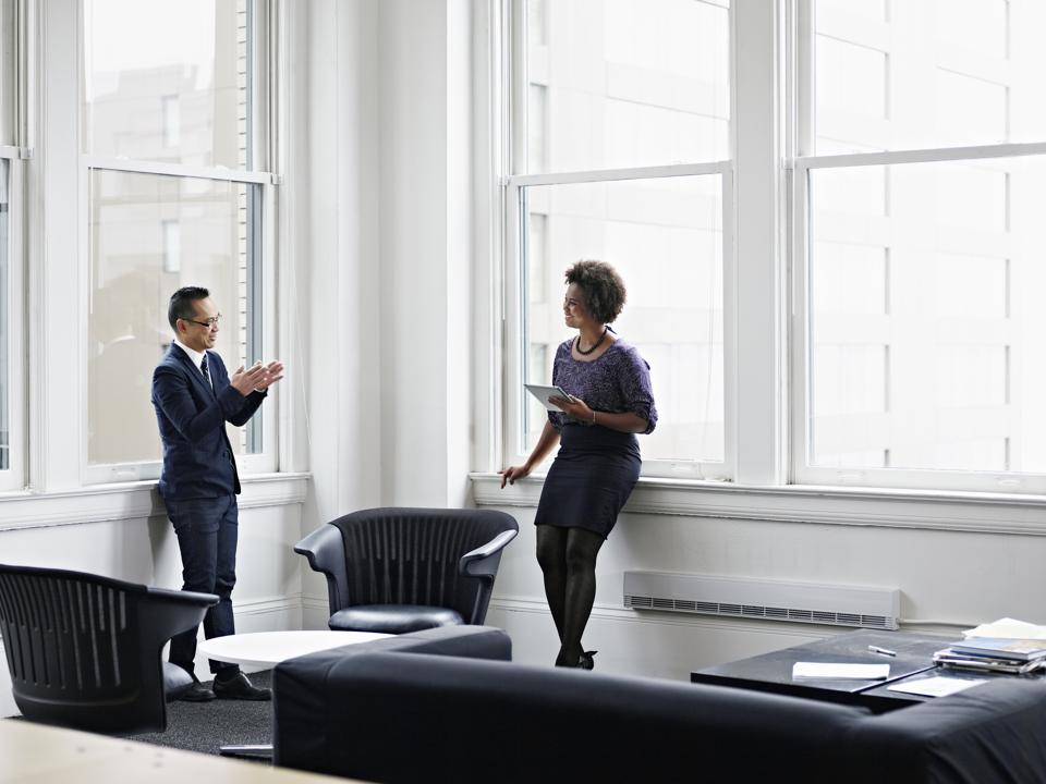 Coworkers discussing project in office