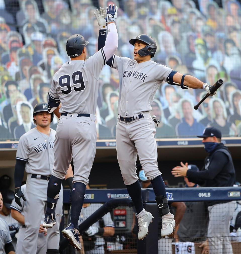 Giancarlo Stanton and Aaron Judge (#99) celebrate.