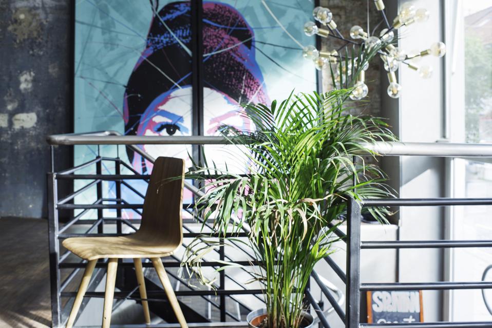 A large painting of a woman looks at the dining room at Spontan wine bar in Trondheim