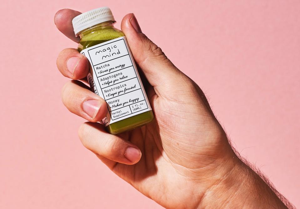 Hand holding Magic Mind bottle