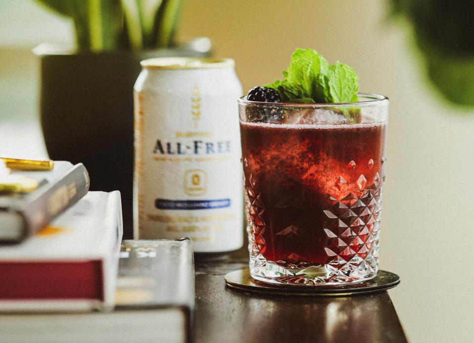 Can of ALL-FREE with a blackberry cocktail glass.