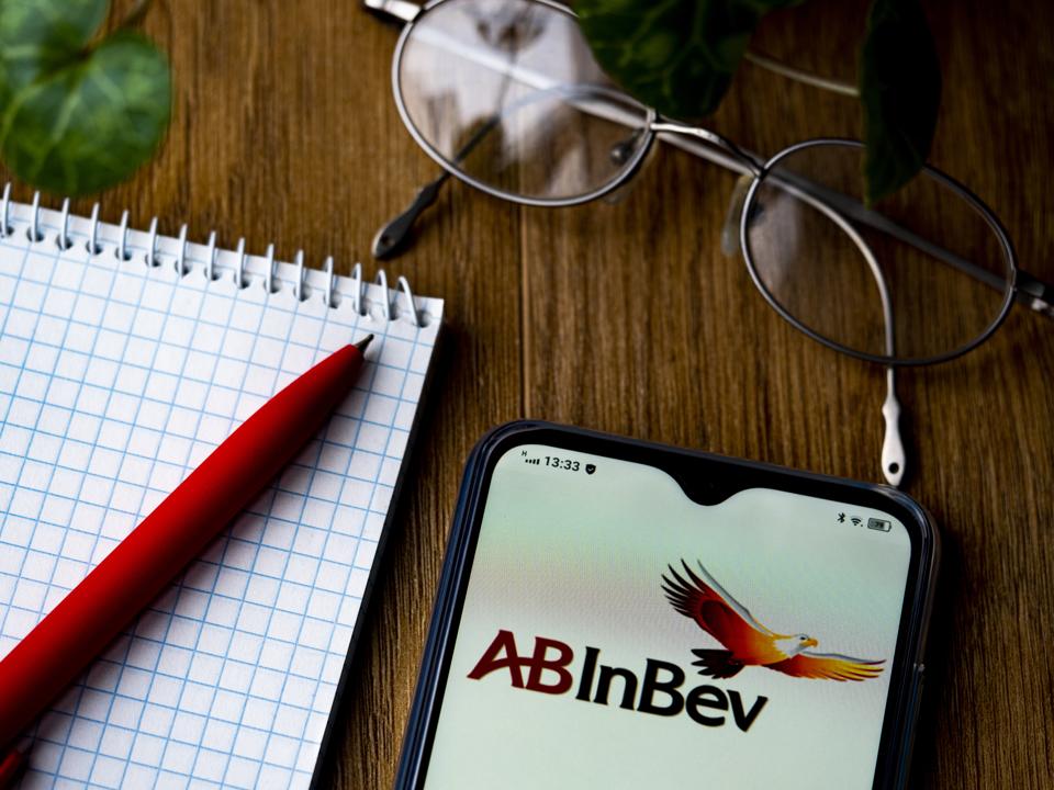 In this photo illustration an Anheuser-Busch InBev, logo is...