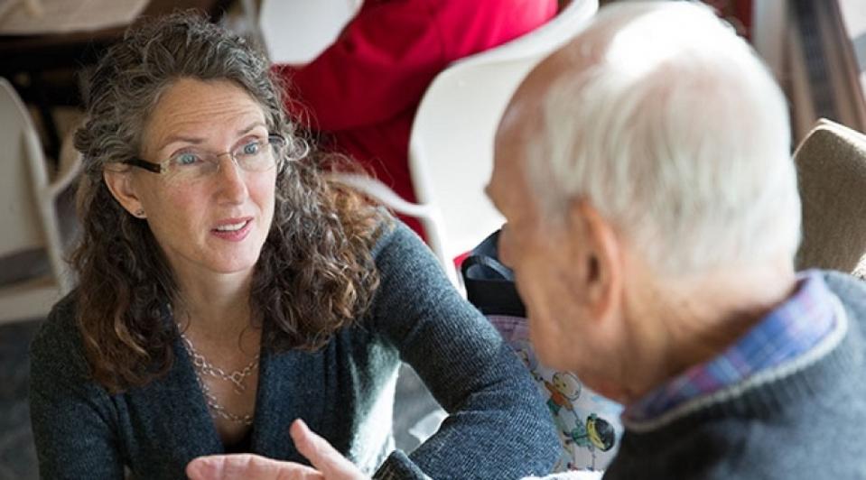 woman talking to man at nursing home
