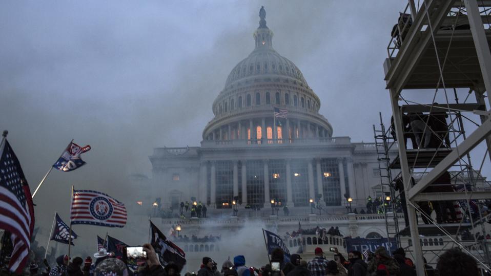 Security forces respond with tear gas after the US President...