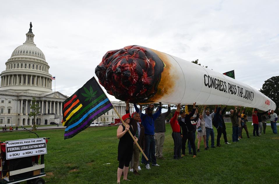 Activists with DCMJ display a giant inflatable joint outside the U.S. Capitol in support of cannabis legalization.