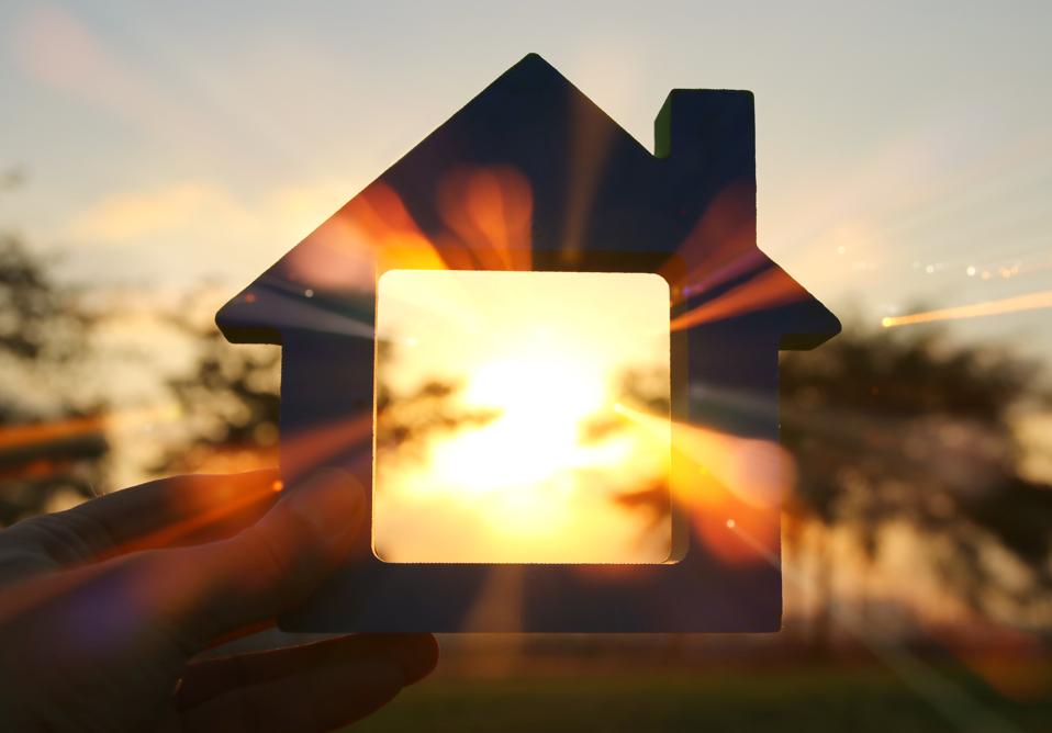 Abstract image of a house at sunset with light coming through it.