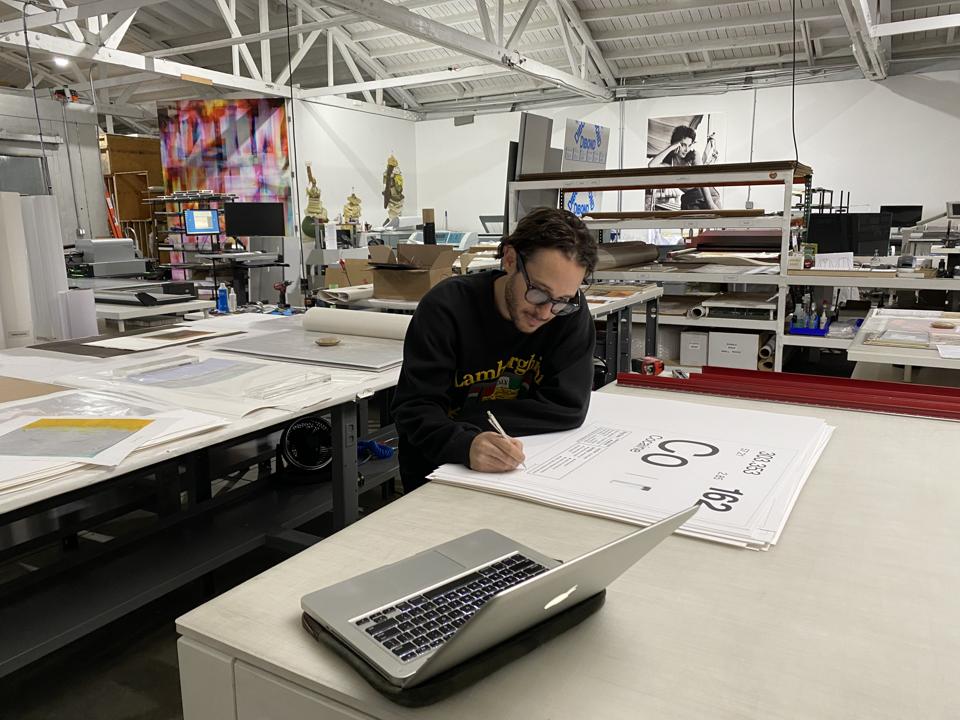Artist Daniel Allen Cohen works on Periodic Tables of Drug and Periodic Tables of Addiction in his studio for This Is Addictive.