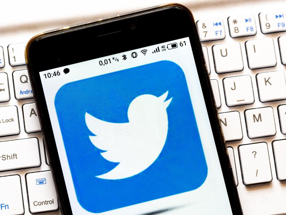 In this photo illustration a Twitter logo is seen displayed...