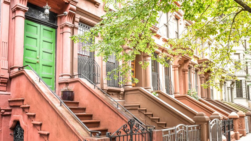 Main ladder and entry door. New york Harlem buildings. Brown houses. NYC, USA.