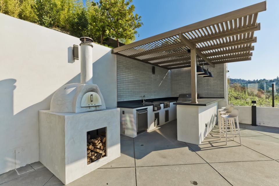 An outdoor kitchen and pizza oven.