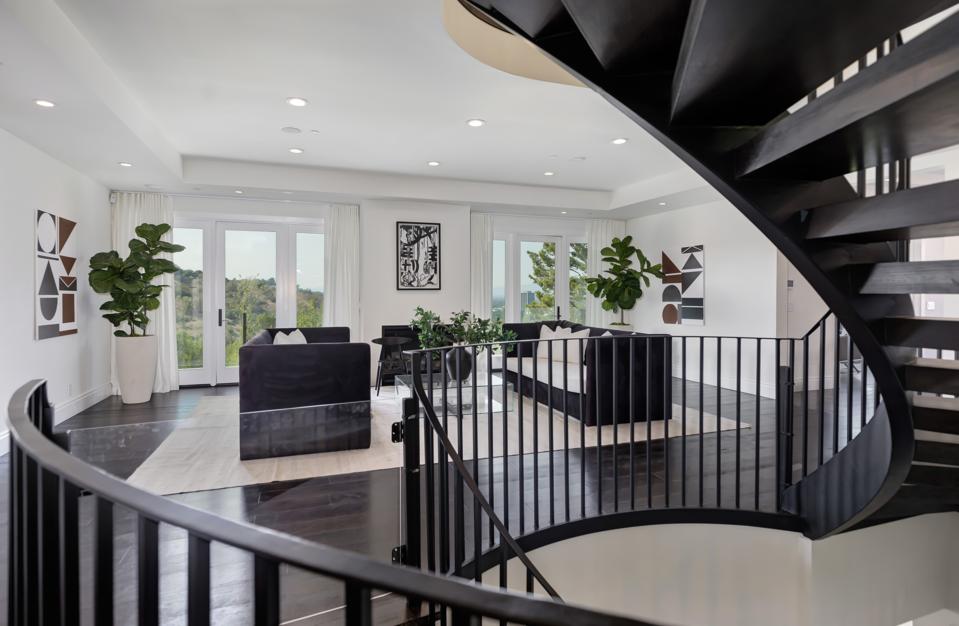 A living room and circular staircase.