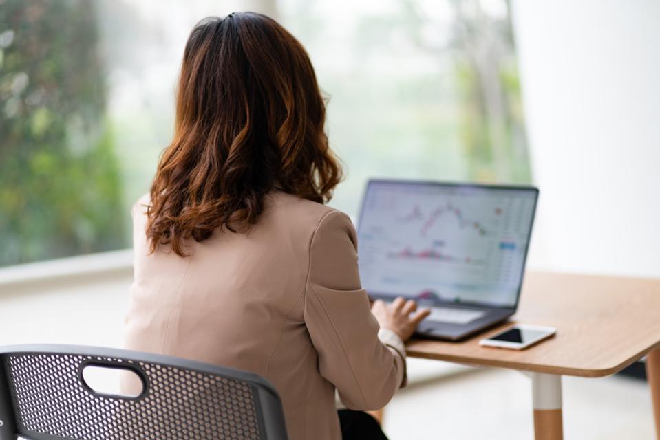 Watching stock market on laptop