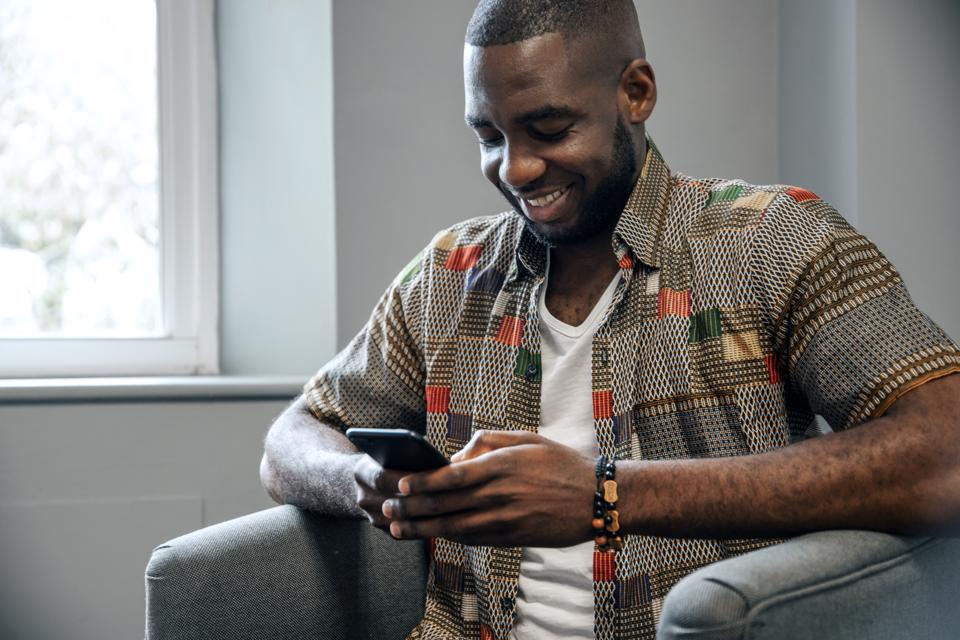 Young African Man Use Smart Phone
