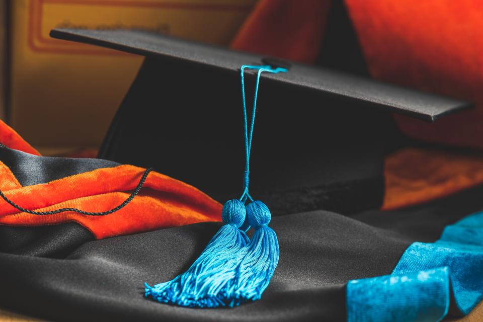 PhD graduate in black gown University degree