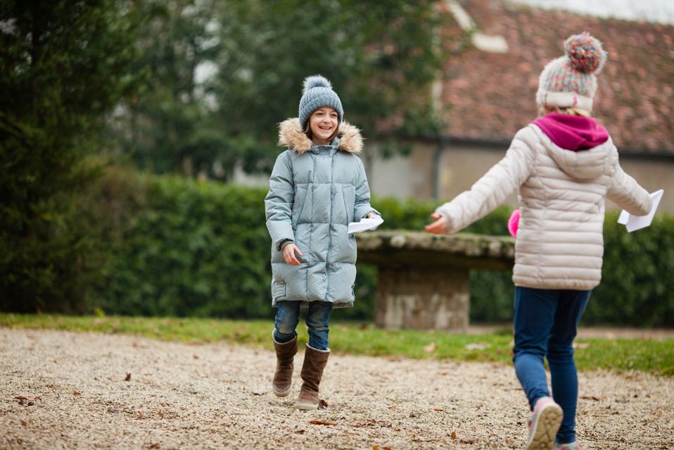 Two girls playing outdoors.