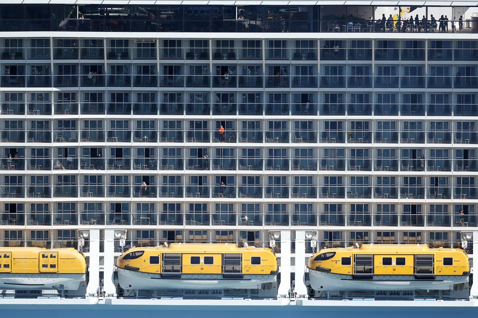 Crew onboard Spectrum of the Seas as it departs Sydney Harbour on April 04, 2020 in Australia.