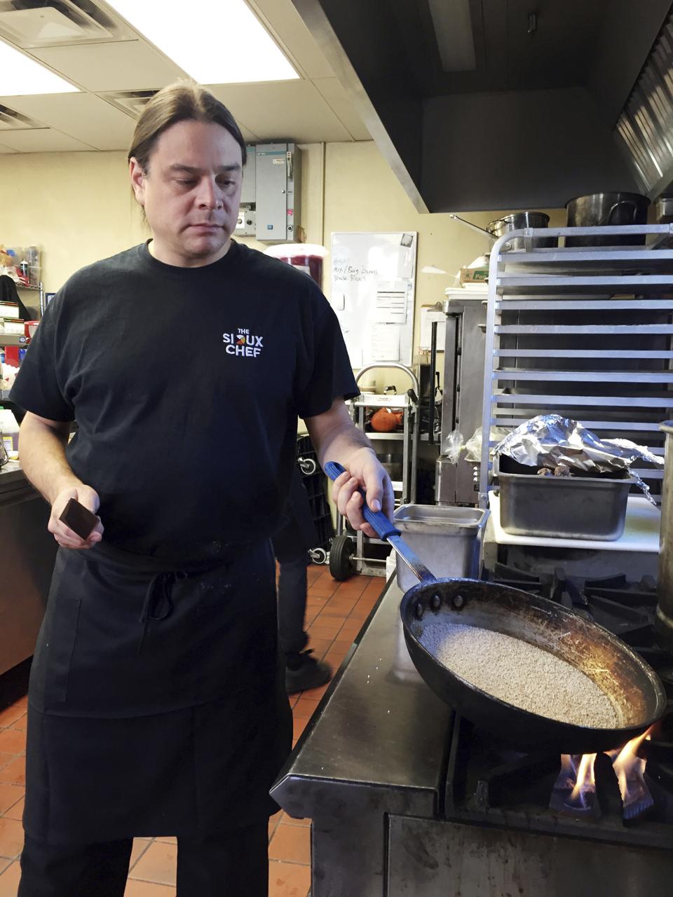 Sioux Chef Sean Sherman shone cooking in a restaurant.