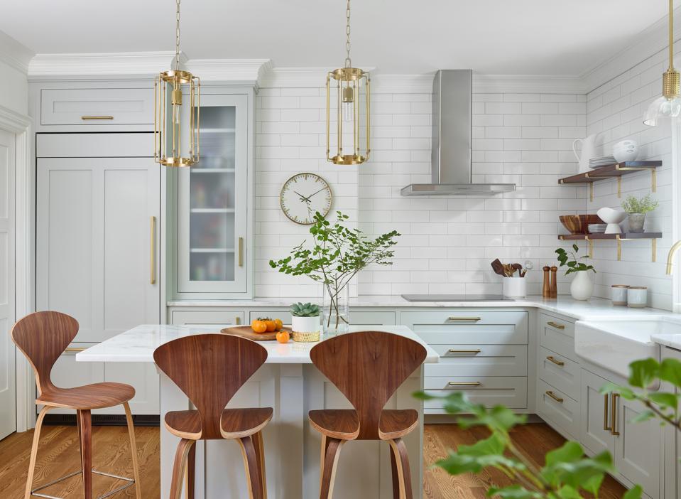 Paneled refrigerator in compact kitchen.