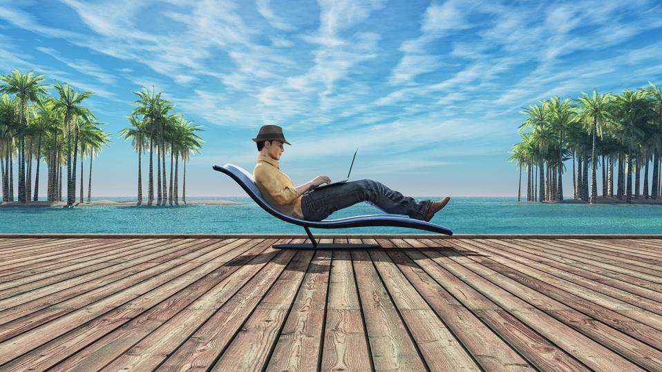 Man with laptop on a beach