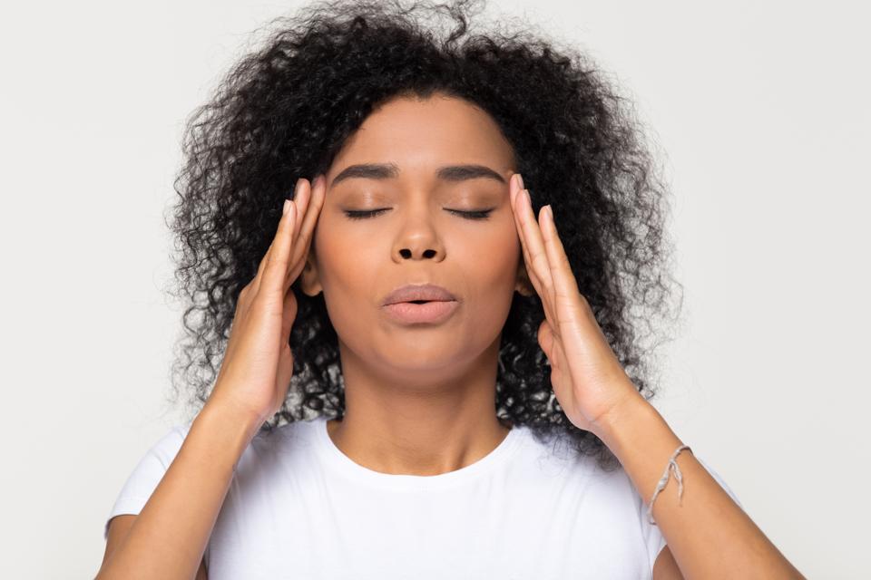 Nervous african woman breathing calming down trying to relieve stress