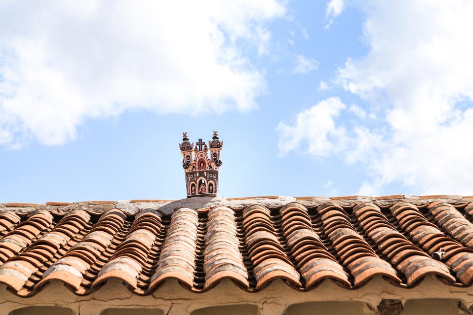 A small hand-carved church on an Andean rooftop