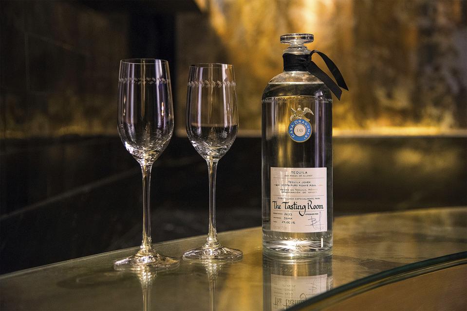 The bar of the tasting room featuring a bottle of Casa Dragones tequila and two glasses.