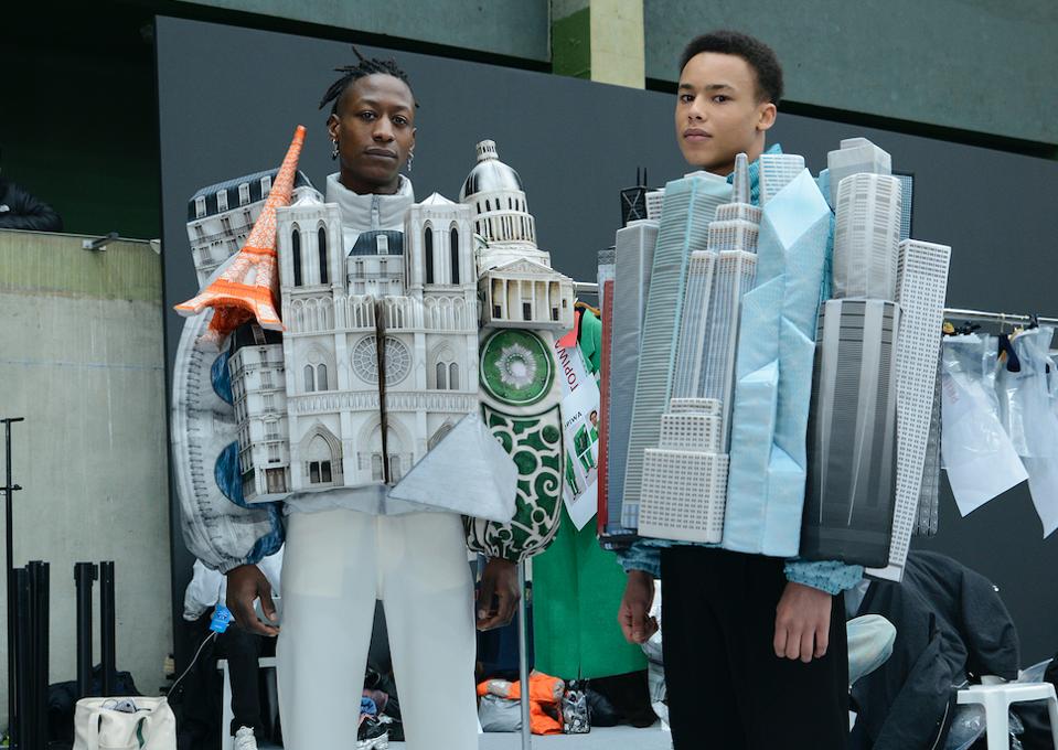 Two male models wearing jackets that depicted famous landmark buildings in New York and Paris