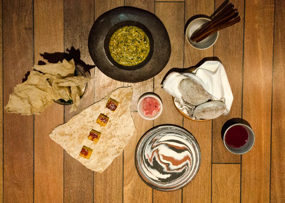 Typical ingredients like corn from the Andres in Peru are presented on special plates